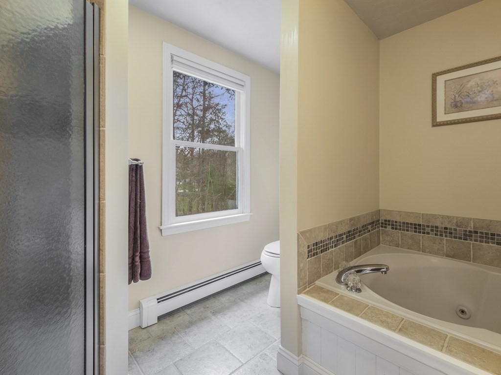2 Deer Run Road Easton, MA 02356 - Photo 31 of 42 a white bath tub sitting in a bathroom next to a window
