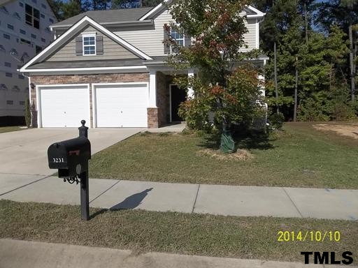 3231 Sunbright Lane Raleigh, NC 27610 - Photo 1 of 15 a front view of a house with garden