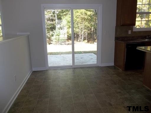 3231 Sunbright Lane Raleigh, NC 27610 - Photo 3 of 15 an empty room with wooden floor and windows