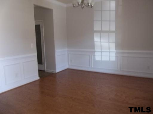 3231 Sunbright Lane Raleigh, NC 27610 - Photo 5 of 15 an empty room with cabinet and windows