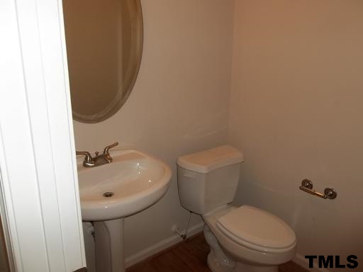 3231 Sunbright Lane Raleigh, NC 27610 - Photo 6 of 15 a bathroom with a sink and a toilet