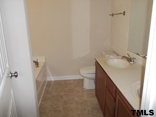3231 Sunbright Lane Raleigh, NC 27610 - Photo 8 of 15 a bathroom with a sink a toilet and shower