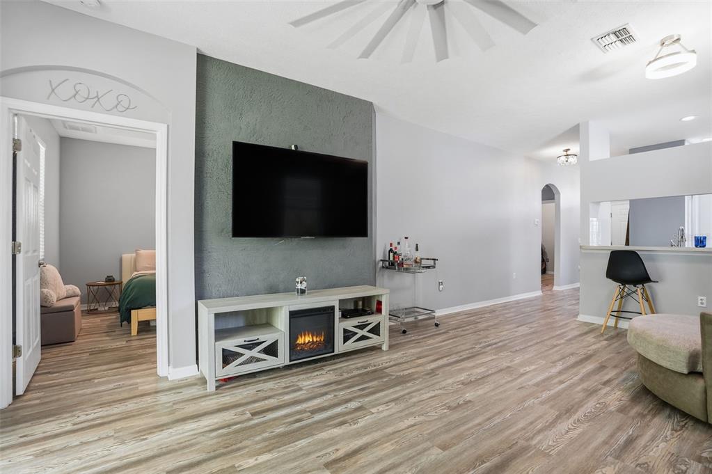 12505 Cavalier Court Hudson, FL 34669 - Photo 11 of 36 a living room with furniture and a flat screen tv