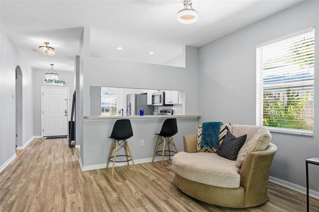 12505 Cavalier Court Hudson, FL 34669 - Photo 12 of 36 a living room with furniture and a large window