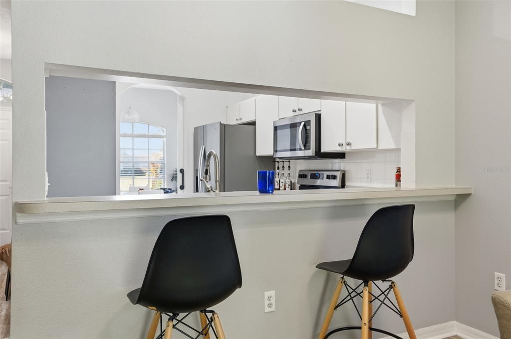 12505 Cavalier Court Hudson, FL 34669 - Photo 13 of 36 a kitchen with stainless steel appliances a sink and a stove