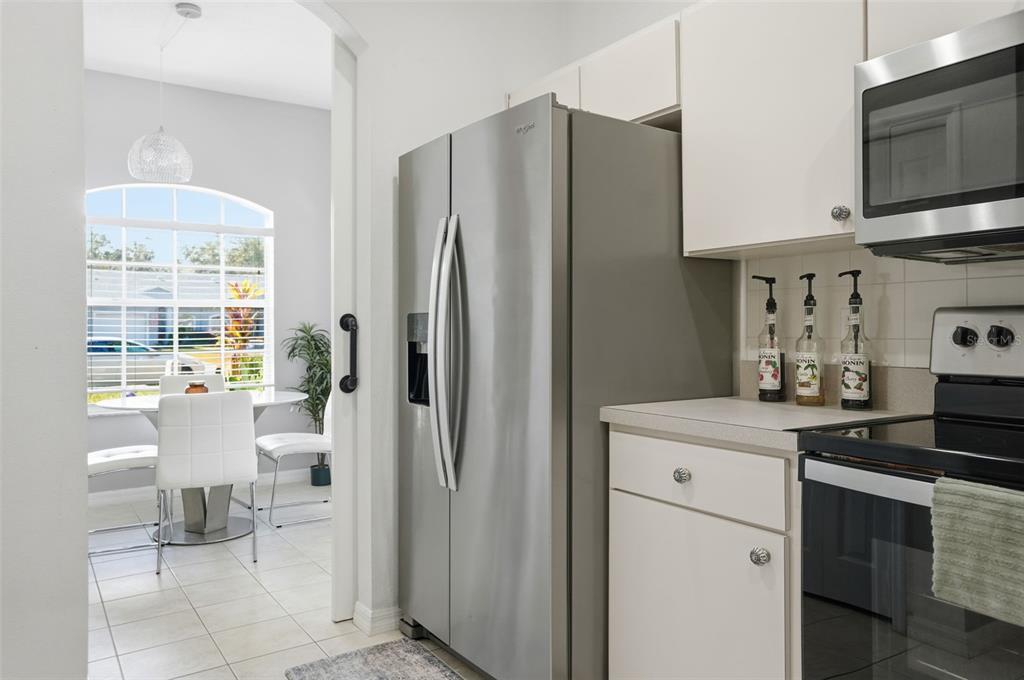 12505 Cavalier Court Hudson, FL 34669 - Photo 17 of 36 a kitchen with stainless steel appliances a refrigerator stove and sink