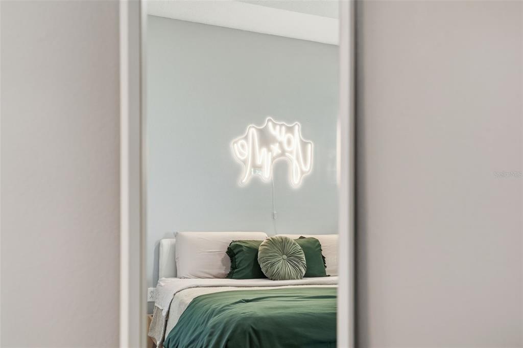 12505 Cavalier Court Hudson, FL 34669 - Photo 24 of 36 a bedroom with a bed and a chandelier