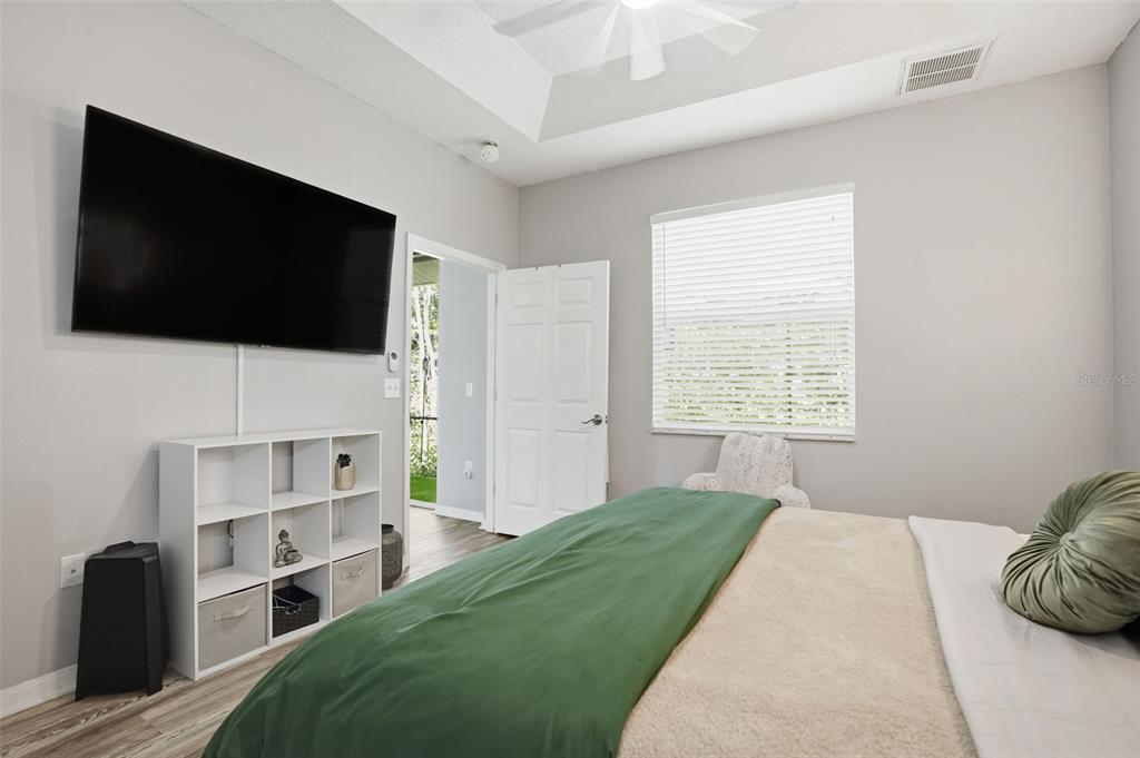 12505 Cavalier Court Hudson, FL 34669 - Photo 25 of 36 a bedroom with a bed and a flat screen tv