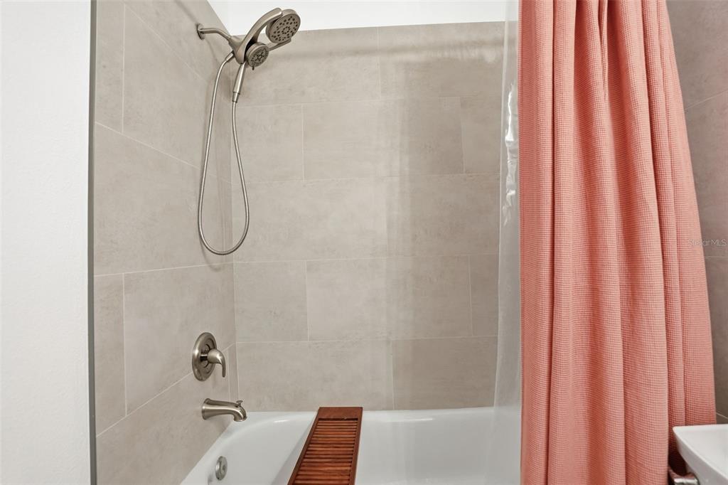 12505 Cavalier Court Hudson, FL 34669 - Photo 27 of 36 a bathroom with a shower curtain and a shower curtain