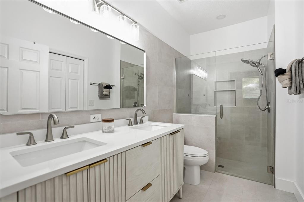 12505 Cavalier Court Hudson, FL 34669 - Photo 28 of 36 a bathroom with a sink a toilet and shower