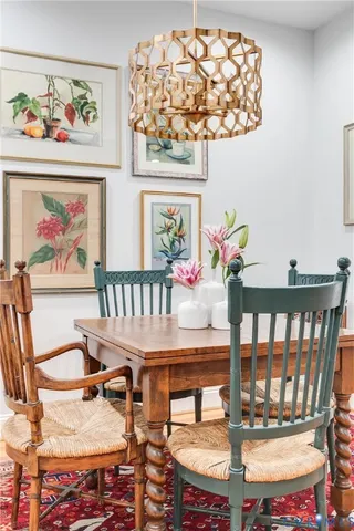 a view of a dining room with furniture a chandelier and wooden floor