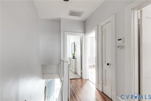 a view of a hallway with wooden floor