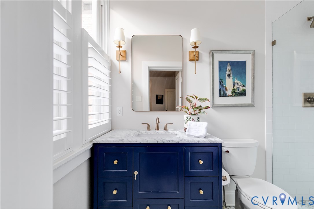 804 Cleveland Street Richmond, VA 23221 - Photo 19 of 25 a bathroom with a sink vanity and a mirror