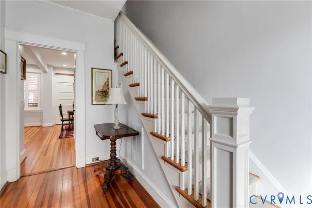 a view of a hallway with furniture and floor to ceiling window