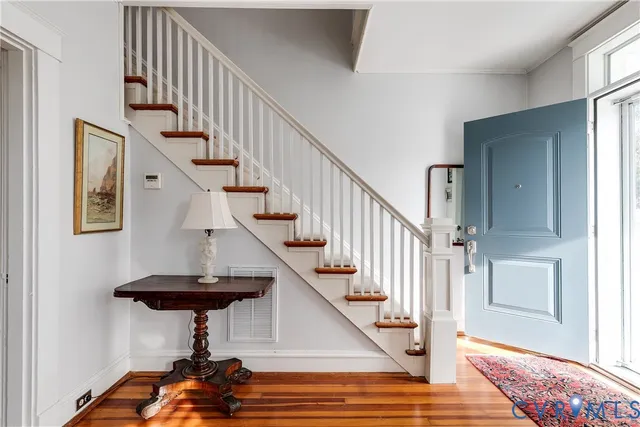 a view of entryway and hall with wooden floor