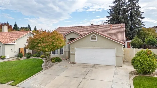a view of a house with a yard and garage
