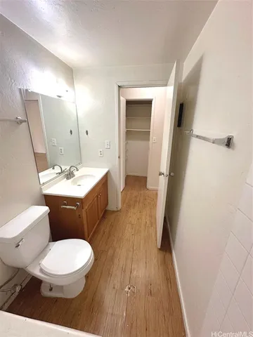 a bathroom with a sink a toilet a mirror and vanity