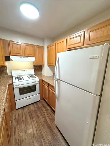 a refrigerator freezer sitting inside of a kitchen