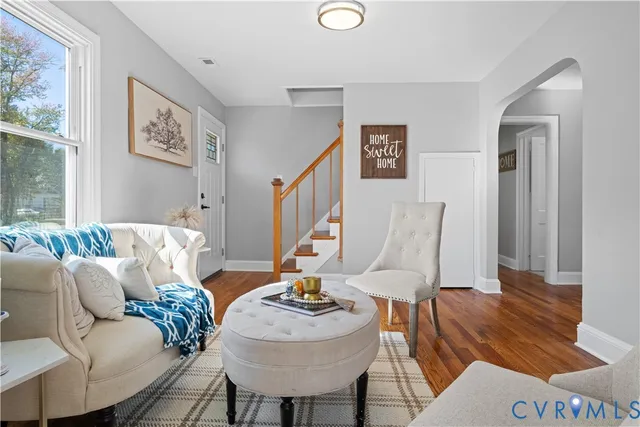 a living room with furniture and wooden floor