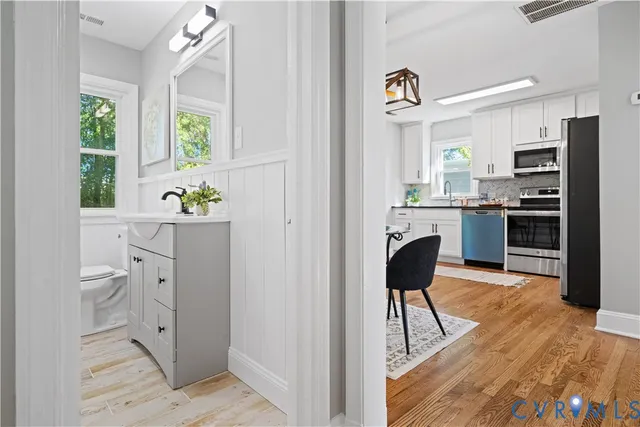 a view of kitchen with stainless steel appliances kitchen island granite countertop a refrigerator and a stove