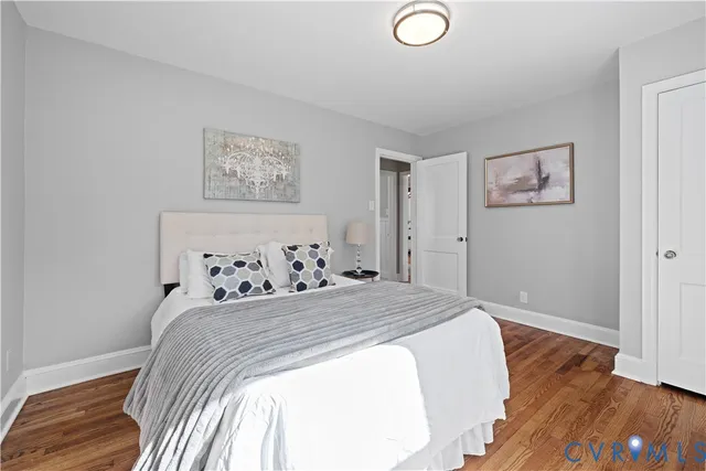 a bedroom with bed and painting on the wall