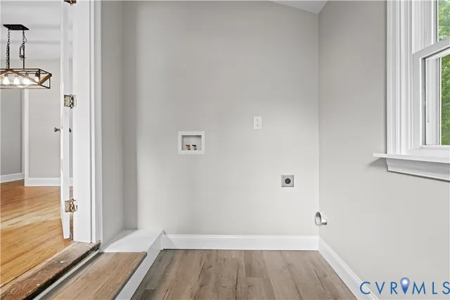 a view of a room with wooden floor and a window
