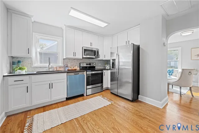 a kitchen with stainless steel appliances a refrigerator sink and cabinets