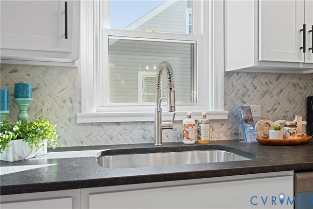 a kitchen with a sink and potted plant