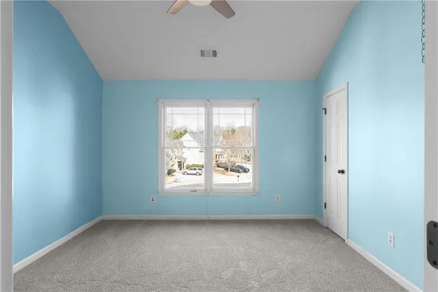 a bathroom with a granite countertop sink a toilet and a mirror