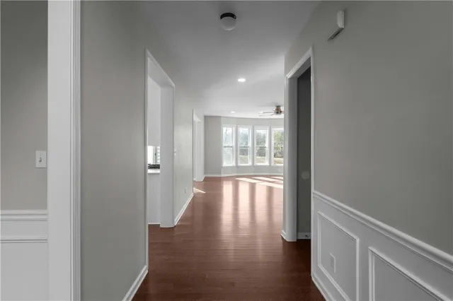 a view of hallway with wooden floor