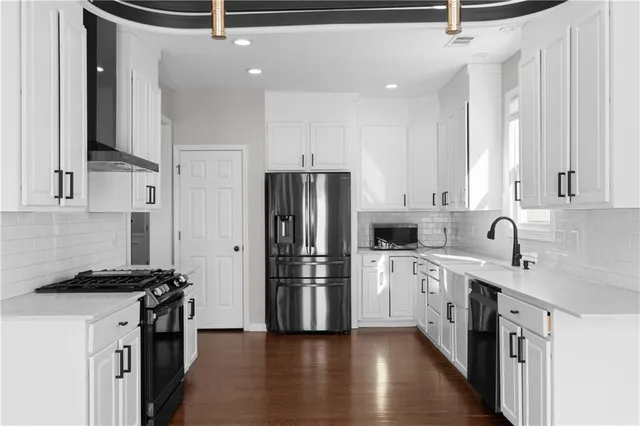 a kitchen with stainless steel appliances a refrigerator sink and cabinets