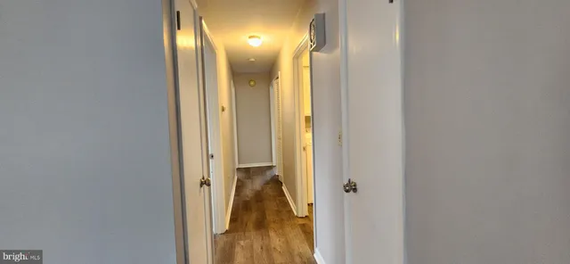 a view of a hallway with a bathroom