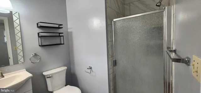 a bathroom with a toilet and a shower