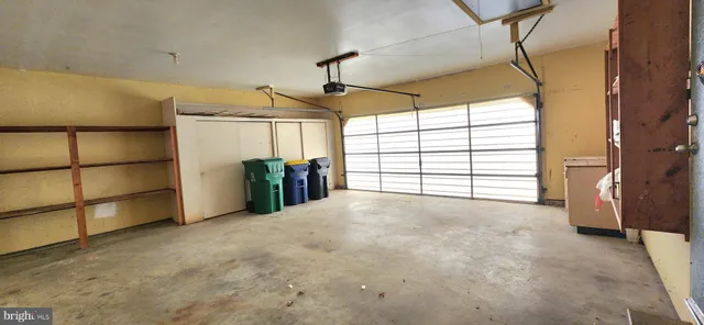 a view of an empty room with window and cabinet