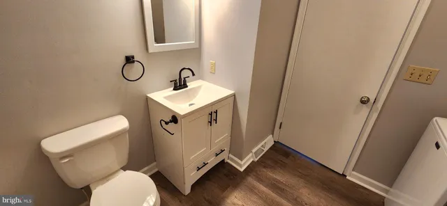 a bathroom with sink toilet and mirror