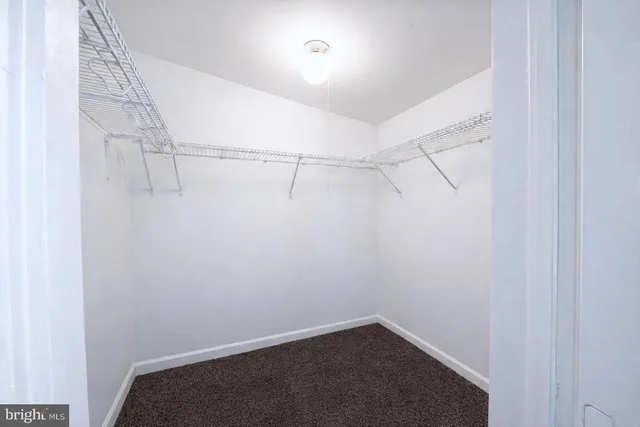 a spacious bedroom with a large bed and a large window