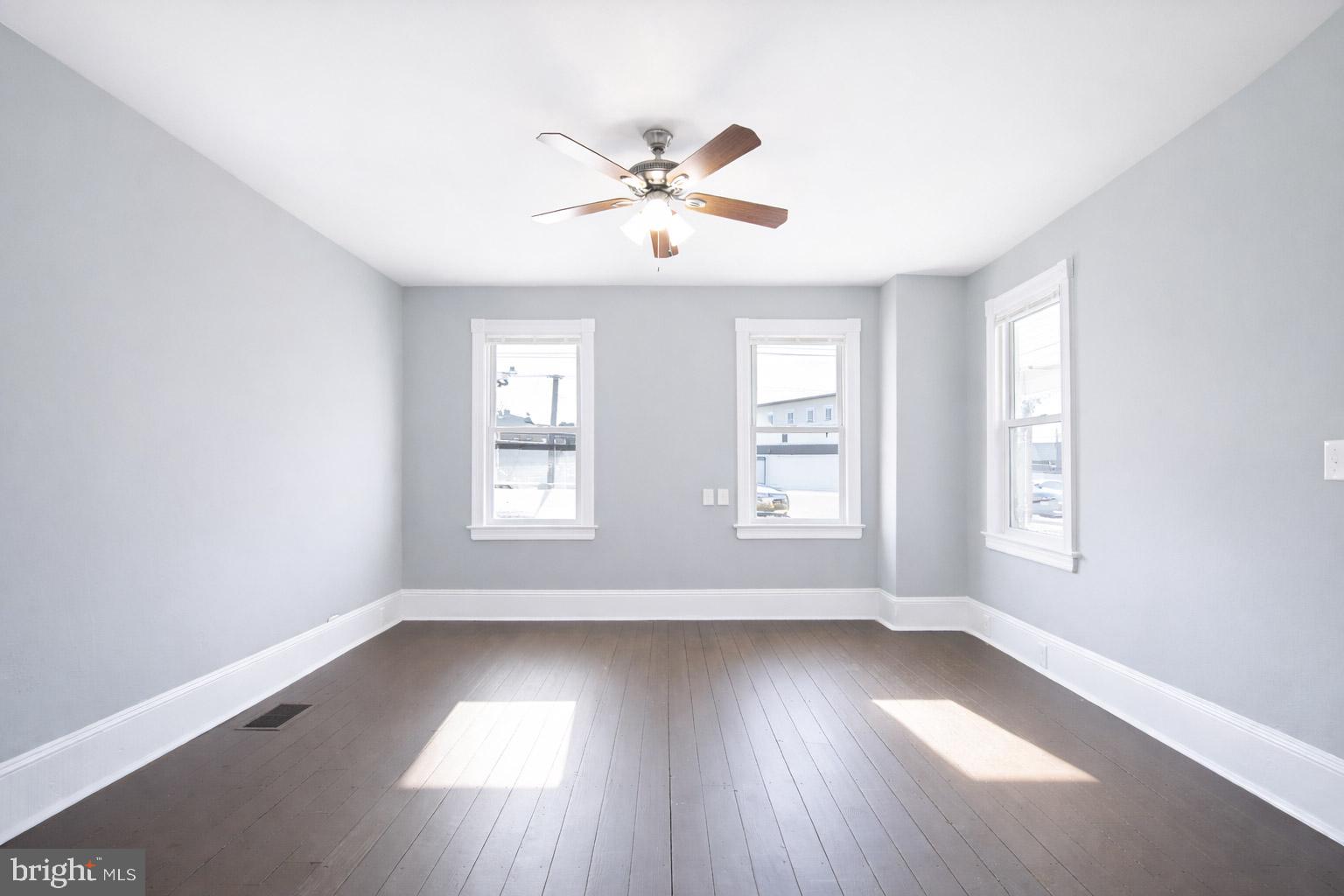 131 Bridgeboro Street Riverside, NJ 08075 - Photo 5 of 21 an empty room with wooden floor windows and fan