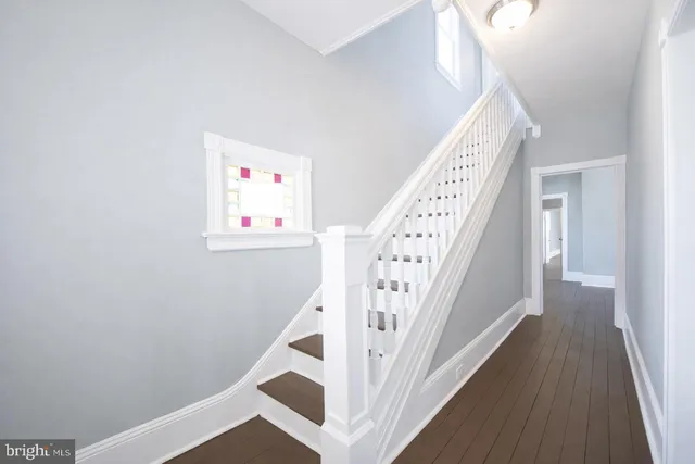 a view of entryway with stairs and wooden floor