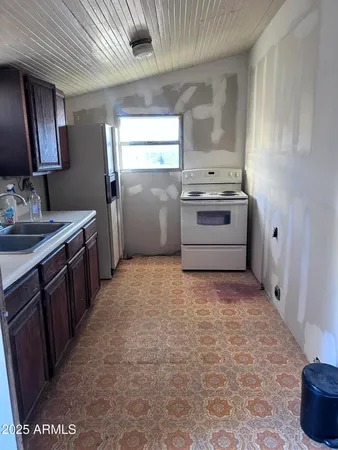 a kitchen with stainless steel appliances granite countertop a refrigerator stove and sink
