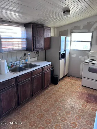 a kitchen with stainless steel appliances granite countertop a refrigerator and a stove