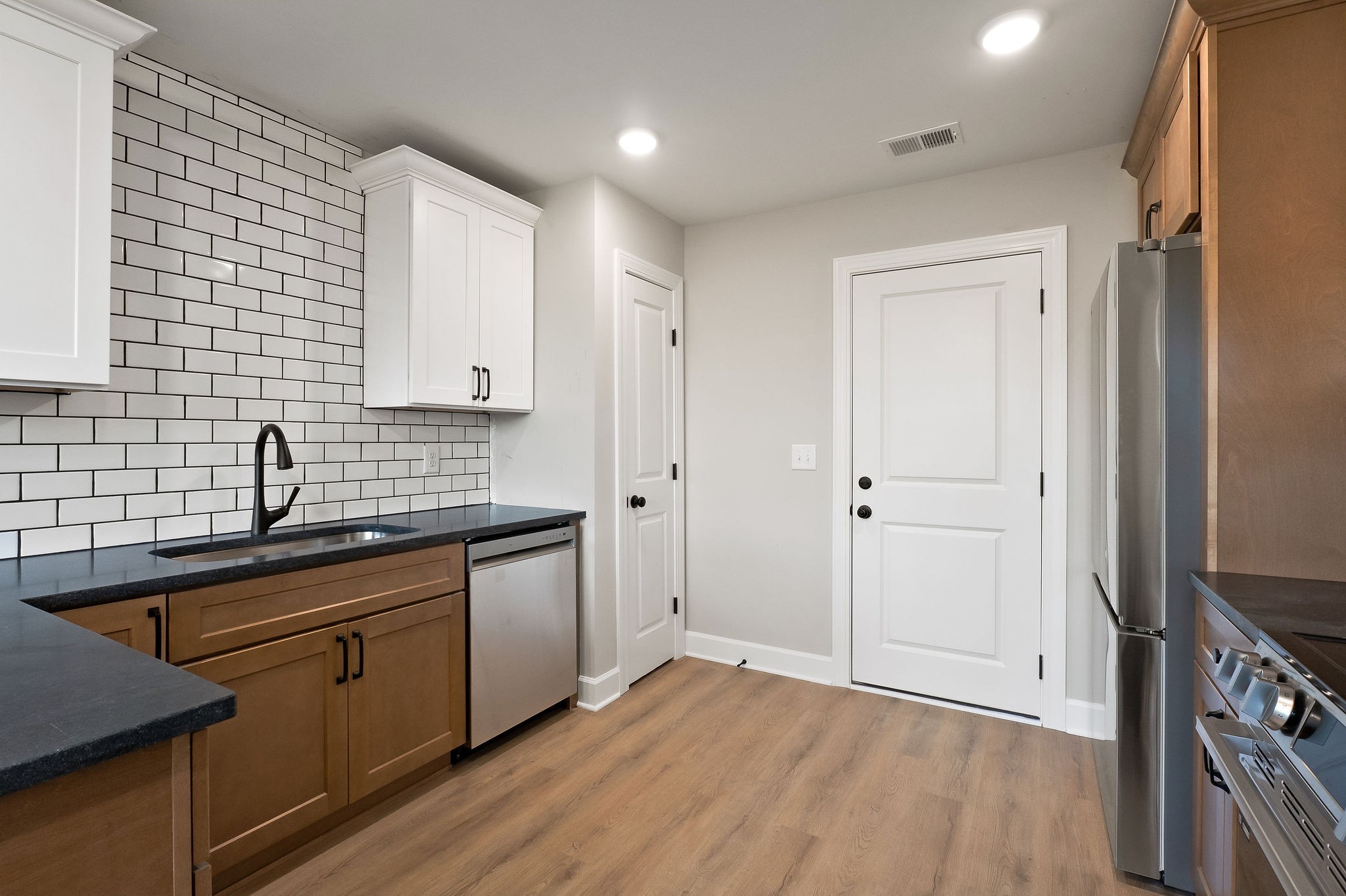 3535 Keltonburg Road Smithville, TN 37166 - Photo 12 of 37 a kitchen with stainless steel appliances granite countertop a sink stove and refrigerator