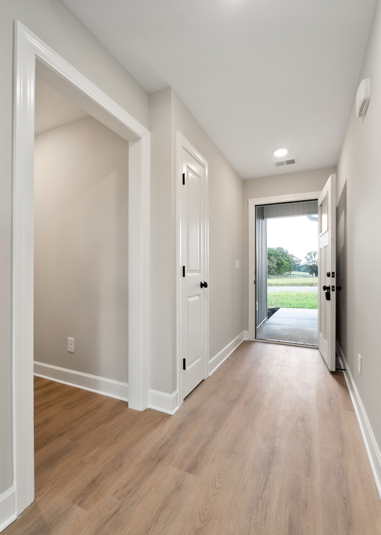 3535 Keltonburg Road Smithville, TN 37166 - Photo 2 of 37 a view of a big room with wooden floor and windows