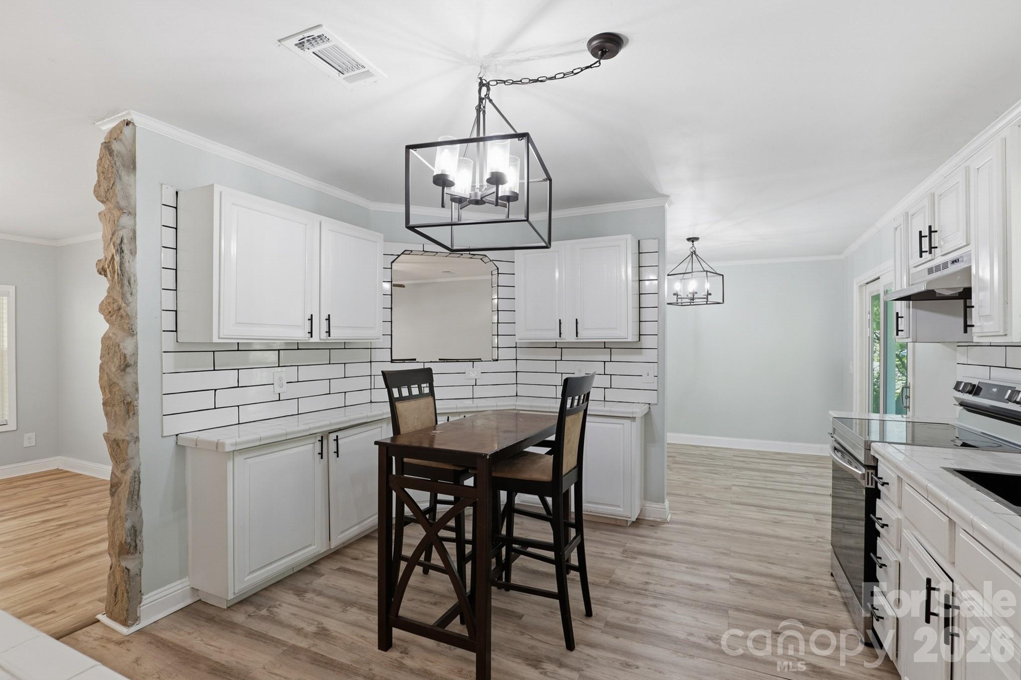 116 Springdale Drive York, SC 29745 - Photo 8 of 32 a view of a dining room with furniture wooden floor and a chandelier