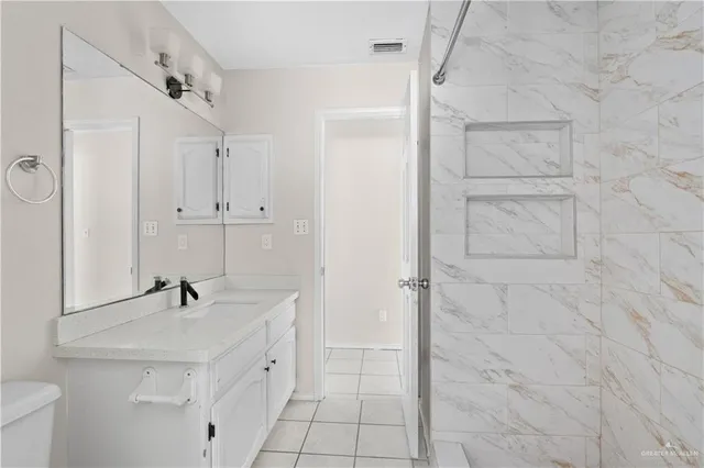 a bathroom with a sink a mirror and shower