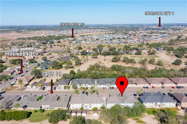 an aerial view of multiple houses with yard