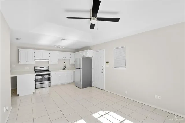 a view of a kitchen with electric appliances