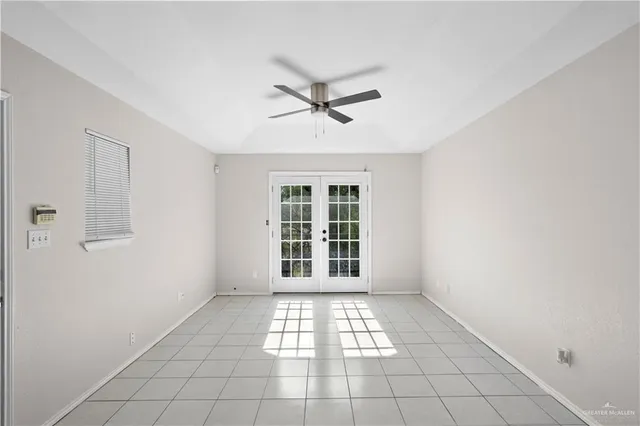 a view of a livingroom with a window and a ceiling fan