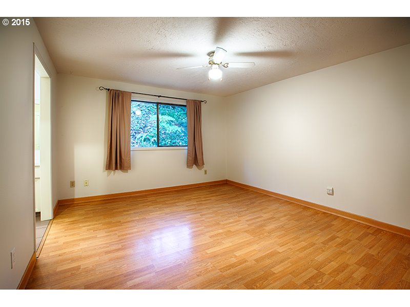 31 Southwest Taylors Ferry Road Portland, OR 97219 - Photo 14 of 23 an empty room with wooden floor and windows