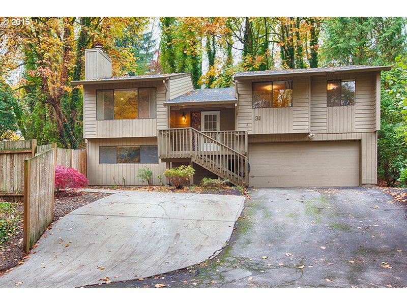 31 Southwest Taylors Ferry Road Portland, OR 97219 - Photo 2 of 23 a front view of a house with a yard and garage