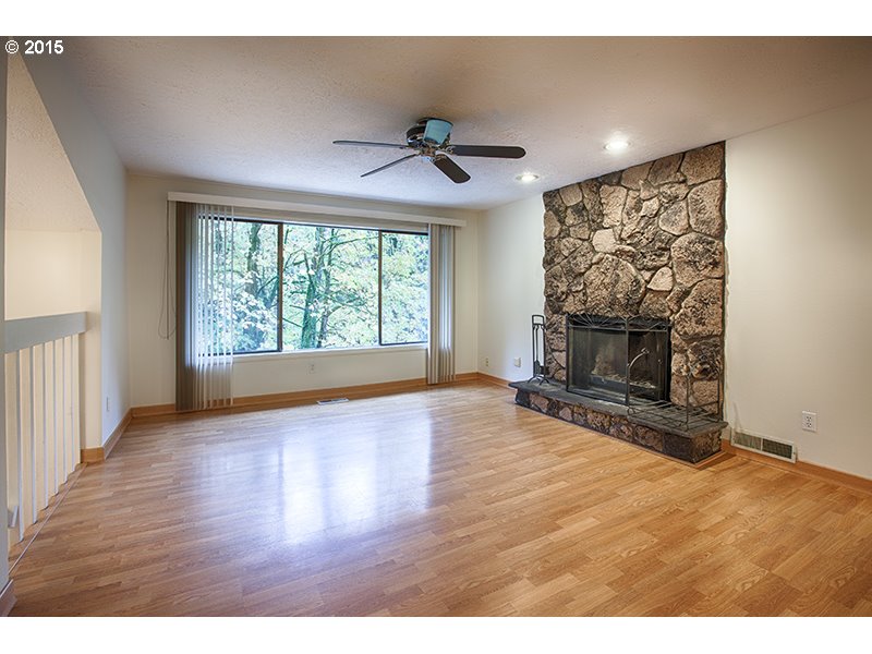 31 Southwest Taylors Ferry Road Portland, OR 97219 - Photo 4 of 23 a view of empty room with fireplace and wooden floor